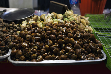 Street food seashells on night street market