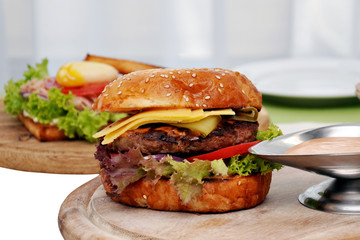 Burger with beef on a wooden Board. Burger with sousana wooden Board.