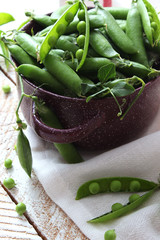 a beautiful composition of green peas and pea pods on a light background.
