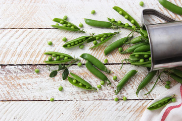 a beautiful composition of green peas and pea pods on a light background.