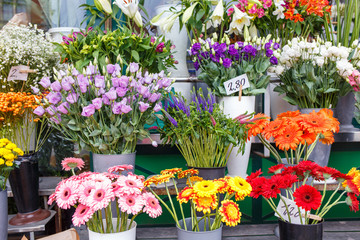 Fototapeta na wymiar Outdoor flower market with roses, peonies and lilies in Vienna, Austria