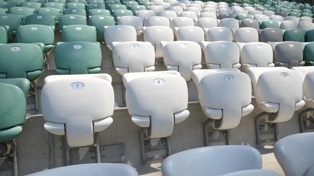 Empty football stadium rows and seats without people and fans slow motion glide camera