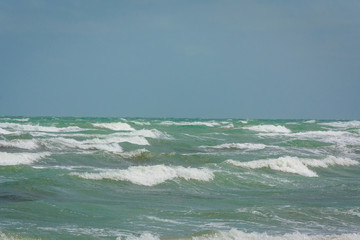 turquoise sea with big waves and blue sky