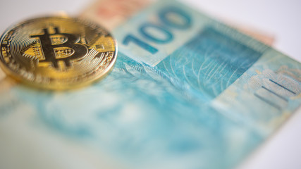 Metal bitcoins and brazilian money notes, Real, Reais. Bitcoin - modern virtual