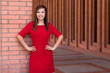 Proud confident graduate student with MBA law degree portrait at university campus, standing with hands on hips