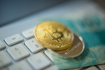 Metal bitcoins and brazilian money notes, Real, Reais. Bitcoin - modern virtual