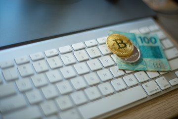 Metal bitcoins and brazilian money notes, Real, Reais. Bitcoin - modern virtual