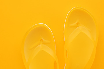 Top view of yellow flip flops pair
