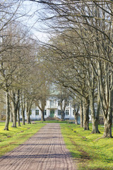 Fototapeta na wymiar Avenue and a gravelled footpath leading to the queen Victorias hotel and rest home outside the city Borgholm at the island Oland in Sweden
