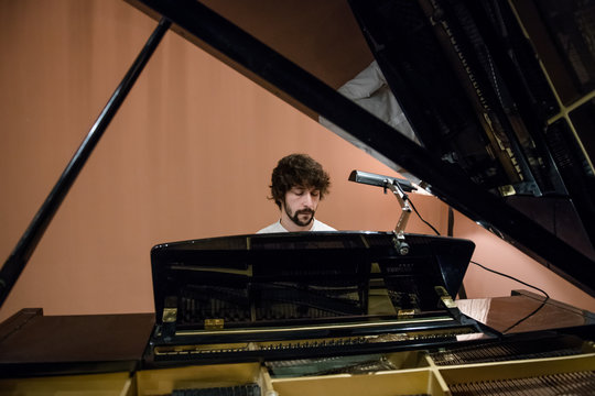 Man playing piano in studio