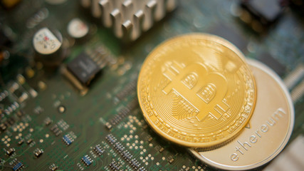 Bitcoin mining process - gold coin on computer circuit board with bitcoin processor and microchips. Electronic currency, internet finance rypto currency concept. Golden Bitcoin Cryptocurrency