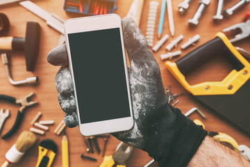 Smart phone app for handyman, repairman holding mobile phone