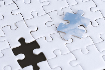 Blue sky piece of pure white jigsaw puzzle,Jigsaw puzzle maybe mean teamwork,work together to success the mission