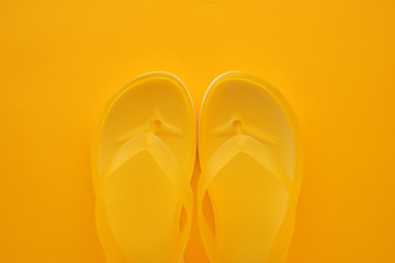 Top view of yellow flip flops pair