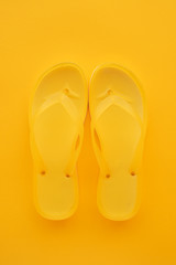 Top view of yellow flip flops pair
