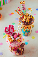 Top view of two freak shakes on party background