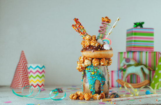 Kids freak shake topping with donut and caramel popcorn with copy space