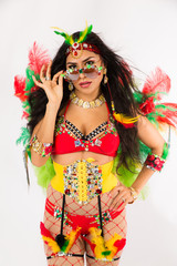 Very fit young hispanic woman in Carnaval costume and athletic shoes posing on clean white background