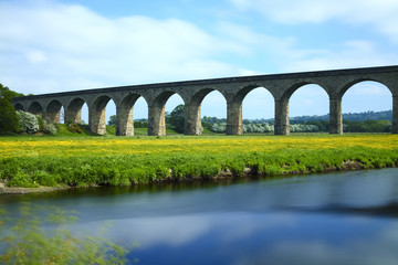 Fototapeta na wymiar Long exposure image of arthington to castley railway viaduct spanning the river wharfe in leeds west yorkshire