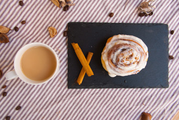 Tasty breakfast with homemade cinnamon roll and fresh coffee. Food background.