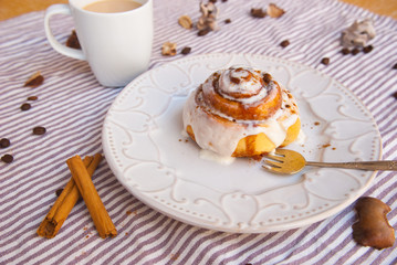 Tasty breakfast with homemade cinnamon roll and fresh coffee. Food background.