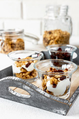 Granola and dessert of cereals and yogurt in a glass jar, Healthy food concept on a light background