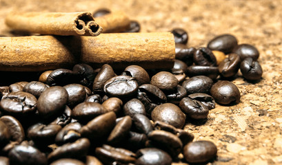 Fresh black coffe beans on cork table
