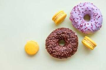 Pop Art Color style donuts and bakery goodies on pastel green background. Unhealthy eating. Sweet dessert for party. Copy space