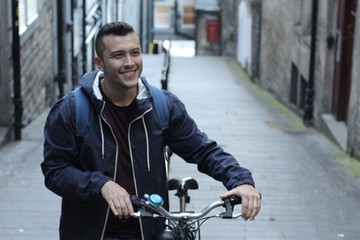 Smiley student heading to campus by bicycle