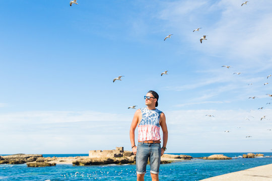 A model posing in the fishing port of Essaouira, Morocco
