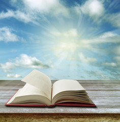 Open book on table and sky