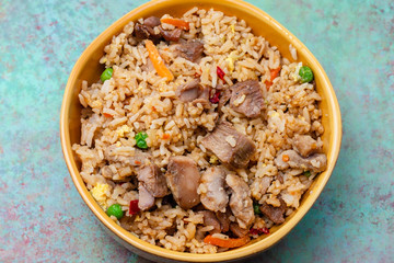 Top view of teriyaki chicken and fried rice on grunge background