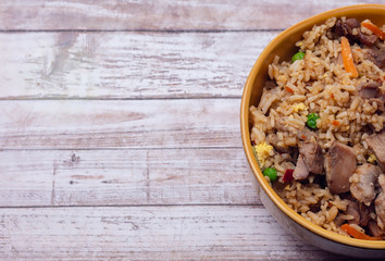 Teriyaki chicken and fried rice on wood table with room for copy text