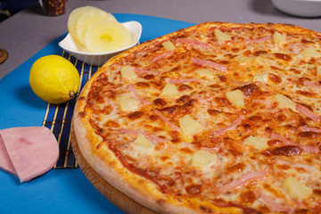 Hawaiian pizza with pineapple.