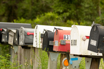 Rural Mailboxes In A Row All Closed Focused On Red