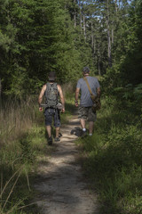 Fototapeta premium Two Male Hikers Going Into National Forest