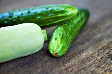 Still life of fresh vegetables. Zucchini (Cucurbita pepo subsp. Pepo) and cucumber (Cucumis sativus). Add to your diet and get vitamins PP, C, B, potassium, magnesium, macro and trace elements.