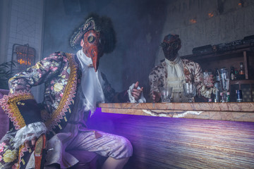 Actors in steam punk masks and antique costumes indoor.