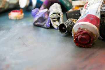 Bright oil paints in a tube on a dirty palette. Paints in use.