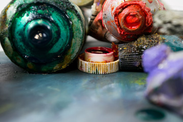 Bright oil paints in a tube on a dirty palette. Paints in use.