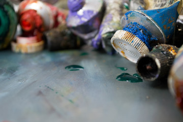Bright oil paints in a tube on a dirty palette. Paints in use.