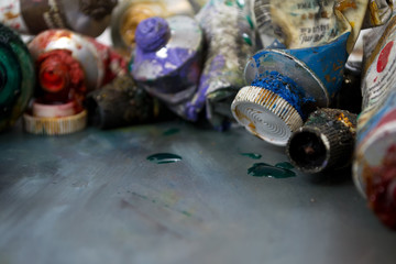 Bright oil paints in a tube on a dirty palette. Paints in use.