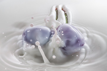 pure falling cherry into milk with splash