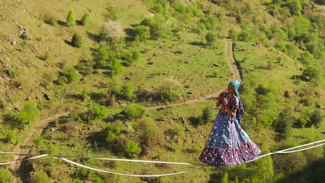 Funambulist in the mountains enjoying nature. slow motion