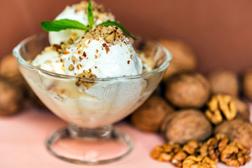 Vanilla ice cream in bowl and walnuts