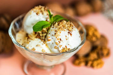 Vanilla ice cream in bowl and walnuts