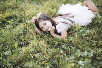 Little kid relax on green grass, health