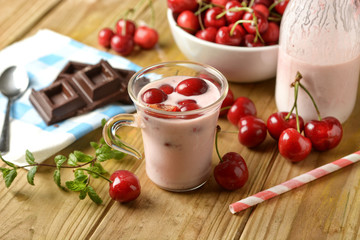 fresh yogurt with red cherries in the glass cup