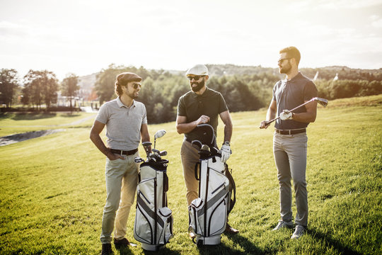 Group Of Friends Walking On The Golf Course