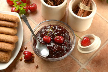 cherry jam in the glass bowl with fruits around